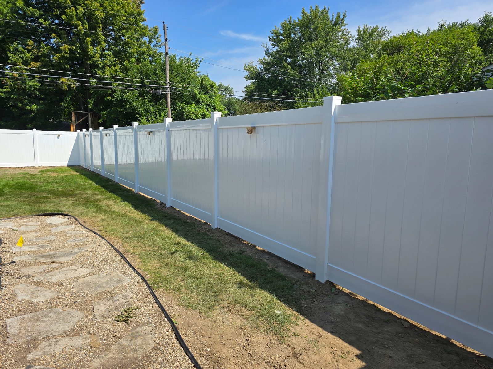 White vinyl privacy fence installed by J&R Fence And Deck